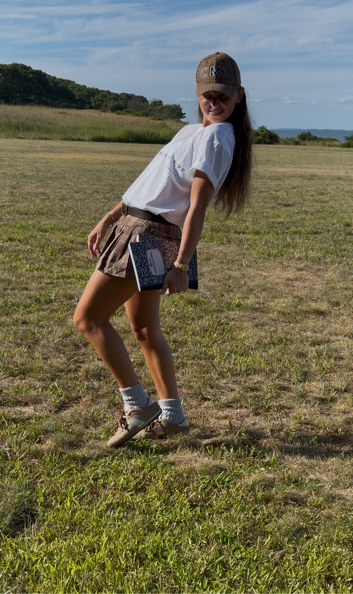 Woman standing in a field wearing a white t-shirt